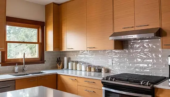 Rift-cut cherry kitchen cabinets with glossy subway tile backsplash and quartz countertop, East Vancouver kitchen renovation